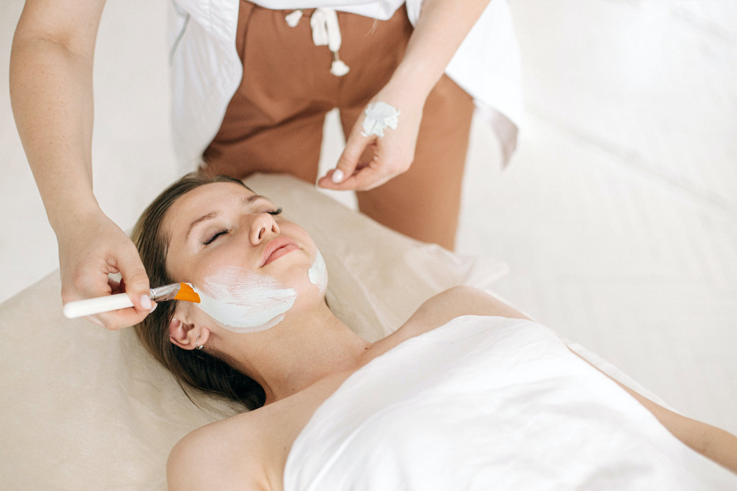 Woman receiving a revitalizing facial or facial treatment at a beauty salon